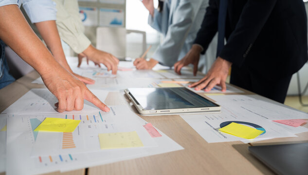 Business hands creating project financial charts and data mind map with colorful sticky notes