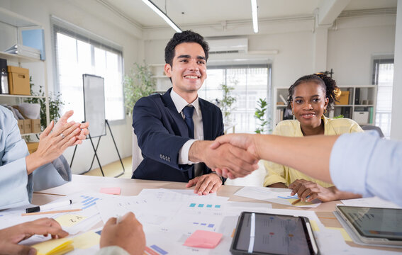 Businessman Handshaking with Partner After Successful Planning Meeting in Office.