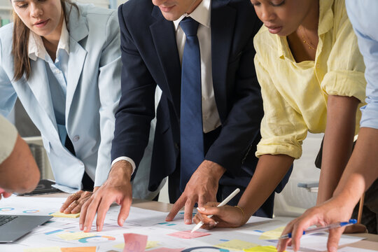 Business hands creating project financial charts and data mind map with colorful sticky notes