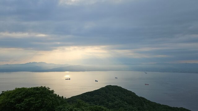 Sunlight breaking through clouds over the sea, viewed from Mount Hakodate, Japan