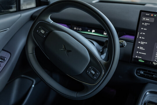 Tallinn, Estonia - May 29 2026: Modern interior of a black XPENG P7 electric sedan. Futuristic cockpit featuring a multifunction steering wheel, panoramic digital instrument display.