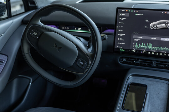 Tallinn, Estonia - May 29 2026: Modern interior of a black XPENG P7 electric sedan. Futuristic cockpit featuring a multifunction steering wheel, panoramic digital instrument display.