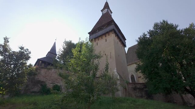 Clock tower and historic walls of Biertan fortified church in Transylvania Romania