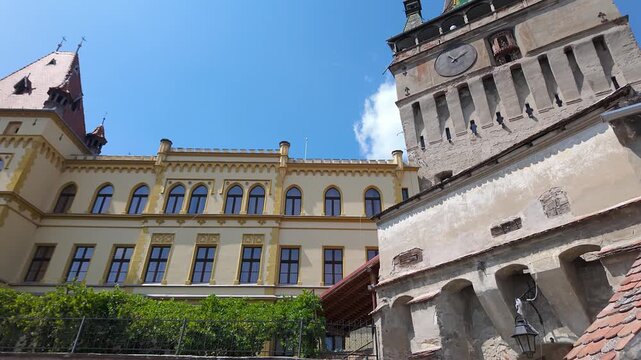 Historic architecture beside Sighisoara Clock Tower in the medieval Old Town of Romania