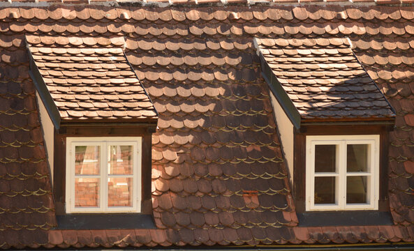 Close view of a traditional tiled roof with dormer windows