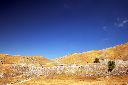 Golden Karst Mountains Under Deep Blue Sky in a Remote Summer Landscape, Bjelasnica, Bosnia and Herzegovina