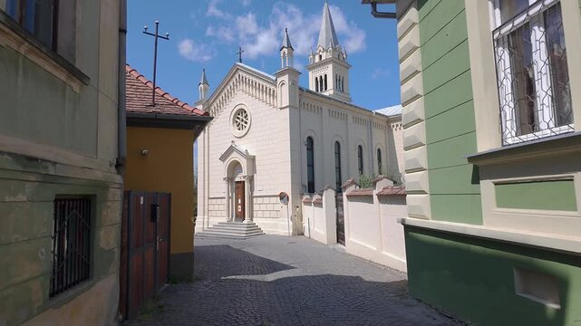 Historic church at the end of a cobblestone street in old town Sighisoara Transylvania Romania