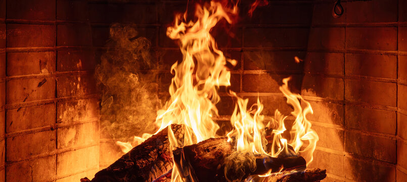Fireplace burning wood logs. Cozy warm home in winter, Christmas time bonfire. Fire flames