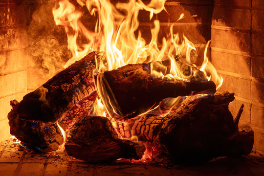 Fireplace burning wood logs. Cozy warm home in winter, Christmas time bonfire. Fire flames