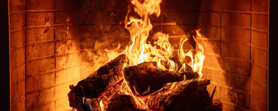 Fireplace burning wood logs. Cozy warm home in winter, Christmas time bonfire. Fire flames