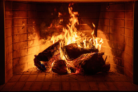 Fireplace burning wood logs. Cozy warm home in winter, Christmas time bonfire. Fire flames