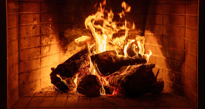 Fireplace burning wood logs. Cozy warm home in winter, Christmas time bonfire. Fire flames