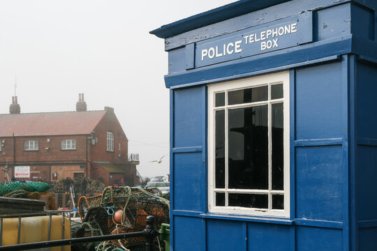 Traditional blue police telephone box in fog in Scarborough England
