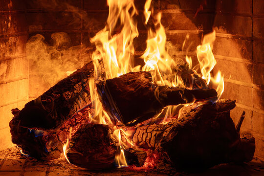 Fireplace burning wood logs. Cozy warm home in winter, Christmas time bonfire. Fire flames