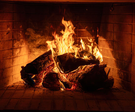 Fireplace burning wood logs. Cozy warm home in winter, Christmas time bonfire. Fire flames