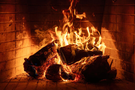 Fireplace burning wood logs. Cozy warm home in winter, Christmas time bonfire. Fire flames