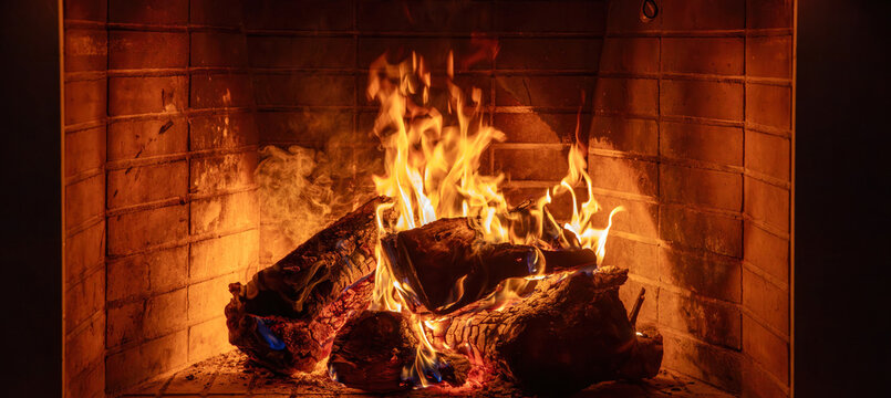 Fireplace burning wood logs. Cozy warm home in winter, Christmas time bonfire. Fire flames