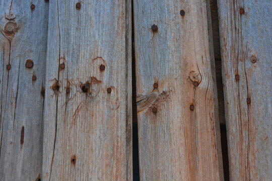 Old objects, artifacts, old wooden grey-orange boards with crumbling, dry paint and rusty nails.