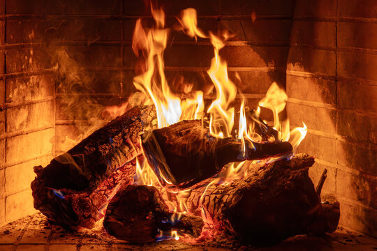 Fireplace burning wood logs. Cozy warm home in winter, Christmas time bonfire. Fire flames
