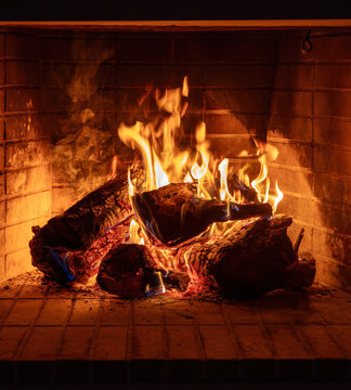 Fireplace burning wood logs. Cozy warm home in winter, Christmas time bonfire. Fire flames