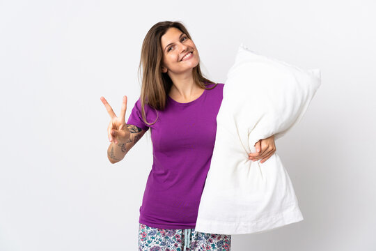 Young slovak woman isolated on white background in pajamas and smiling while showing victory sign