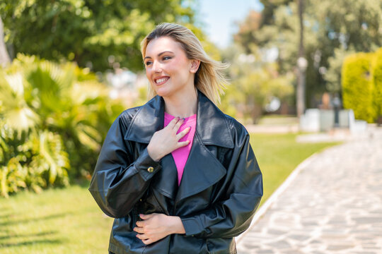 Young pretty blonde woman at outdoors With happy expression