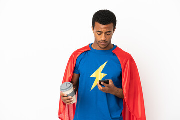 African American Super Hero man over isolated white background holding coffee to take away and a mobile © luismolinero