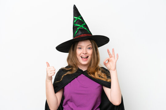 Young pretty woman costume as witch isolated on white background showing ok sign and thumb up gesture