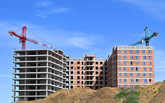 Construction of apartment building and mounds of soil
