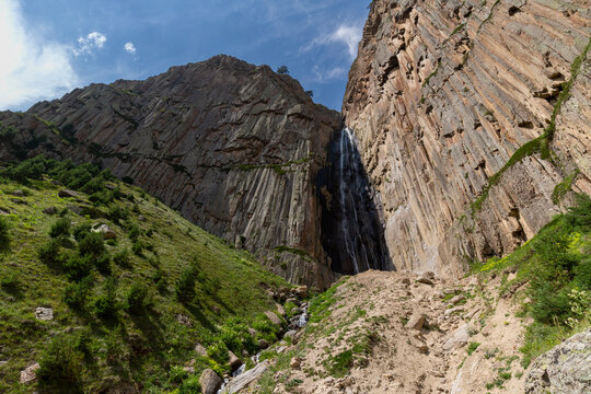 Abai-Su Waterfall, flowing from basalt cliffs in mountain Gorge, North Caucasus