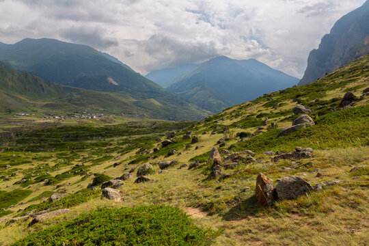 The green slopes and rocky summits of the Caucasus Mountains in Chegem Gorge