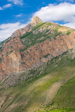 The green slopes and rocky cliffs of the Caucasus Mountains in Chegem Gorge
