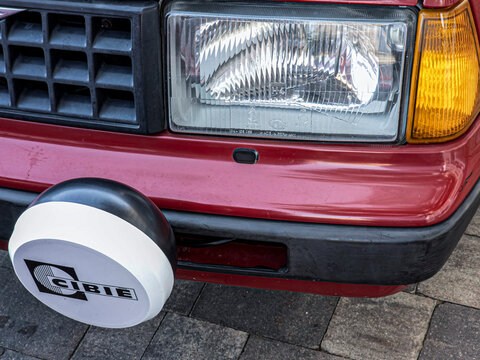 Gandia, Spain - September 19, 2026. Close up of front headlight and Cibi&eacute; spotlight pod on classic red Volvo