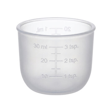 Clear plastic measuring cup with ml and tsp markings isolated white