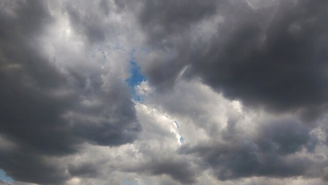 Dramatic Stormy Sky with Dark Clouds and Patch of Blue Sky Breaking Through.
