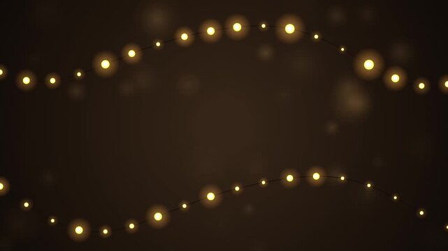 Beautiful glowing string lights twinkle on a dark background creating a warm festive ambience for hol