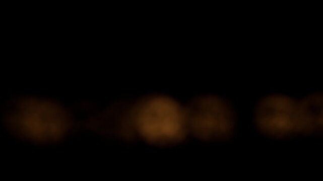 Golden Light Bursts Emerging From a Black Background Over Time