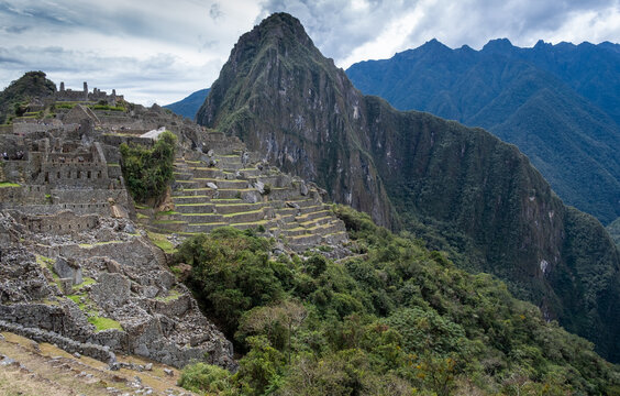 Machu Picchu ancient Inca ruins under cloudy sky in Peru