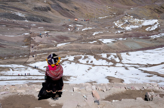 Indigenous woman viewing rainbow mountain vinicunca rainbow mountain landscape