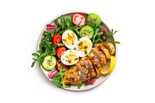 High protein lunch bowl with chicken, eggs and vegetable salad isolated