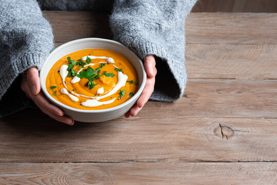 Bowl of lentil soup in woman hands