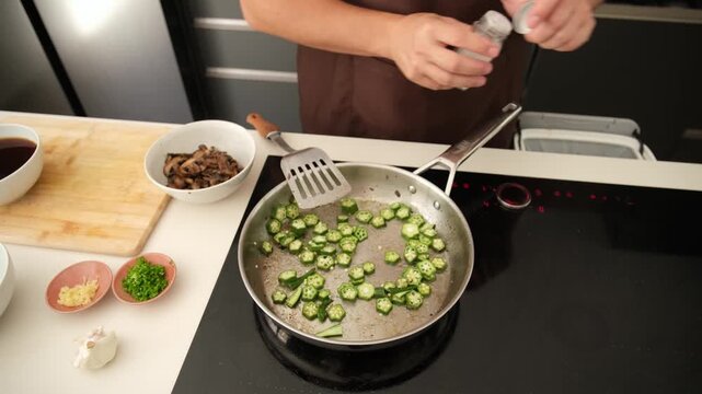 Professional cook preparing a healthy vegetable dish on an induction hob