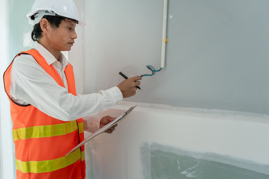 Mechanic or maintenance or electrical engineer checking main electrical control systems industrial plant. Utility fore man daily check power systems in process. Main Distribution Board, Switchboard