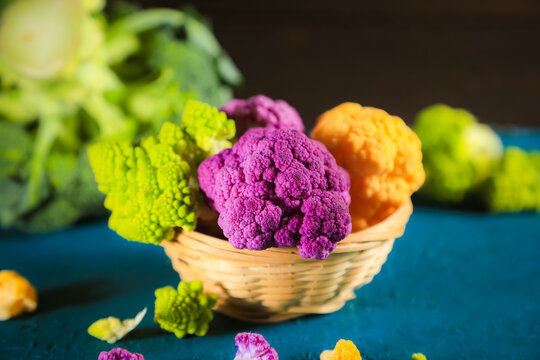 Multicolored cauliflower in a wicker bowl. Rustic still life.