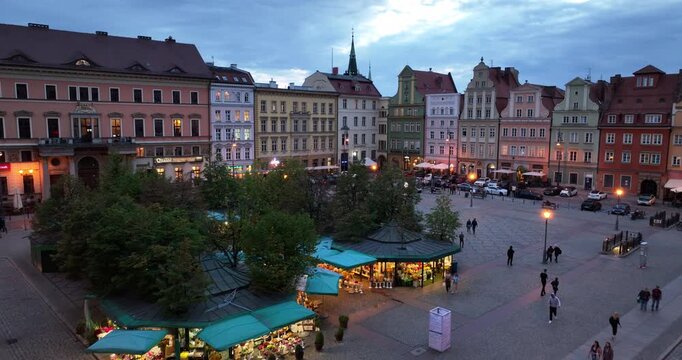 Flyover of Salt Square flower pavilions in Wrocław at dusk