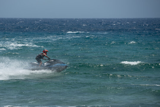 Jet skiing sport on rough waters with splashes and waves
