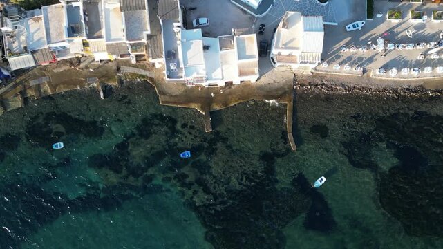 Top Down Aerial of Klima Village Waterfront and Turquoise Sea Milos Greece