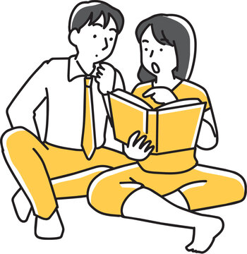 本を見る男性と本の気になる箇所を指差す女性