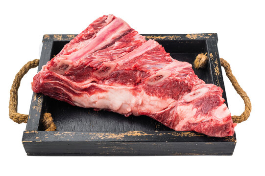 Fresh uncooked beef short ribs slab with visible bones isolated on white background. Protein rich meat for soup stew and BBQ.