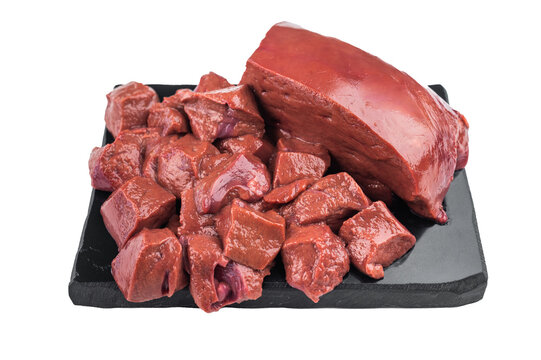 Raw beef liver whole piece with cubed cuts on slate board and knife. Fresh organ meat